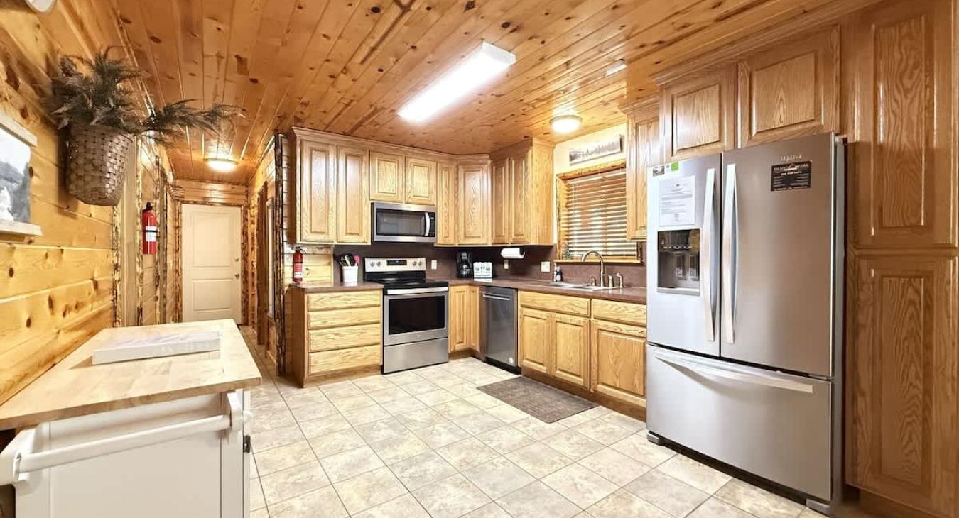 Full size kitchen with appliances, cookware, dishes, and basic cooking essentials.