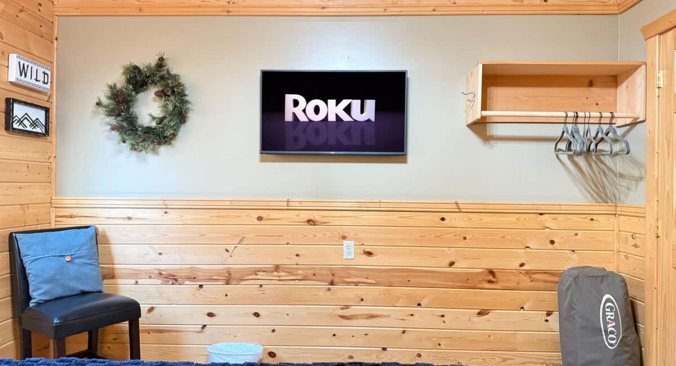 Across from the bed is a flat-screen TV—simple, unobtrusive, ready for late-night movies or quiet mornings.