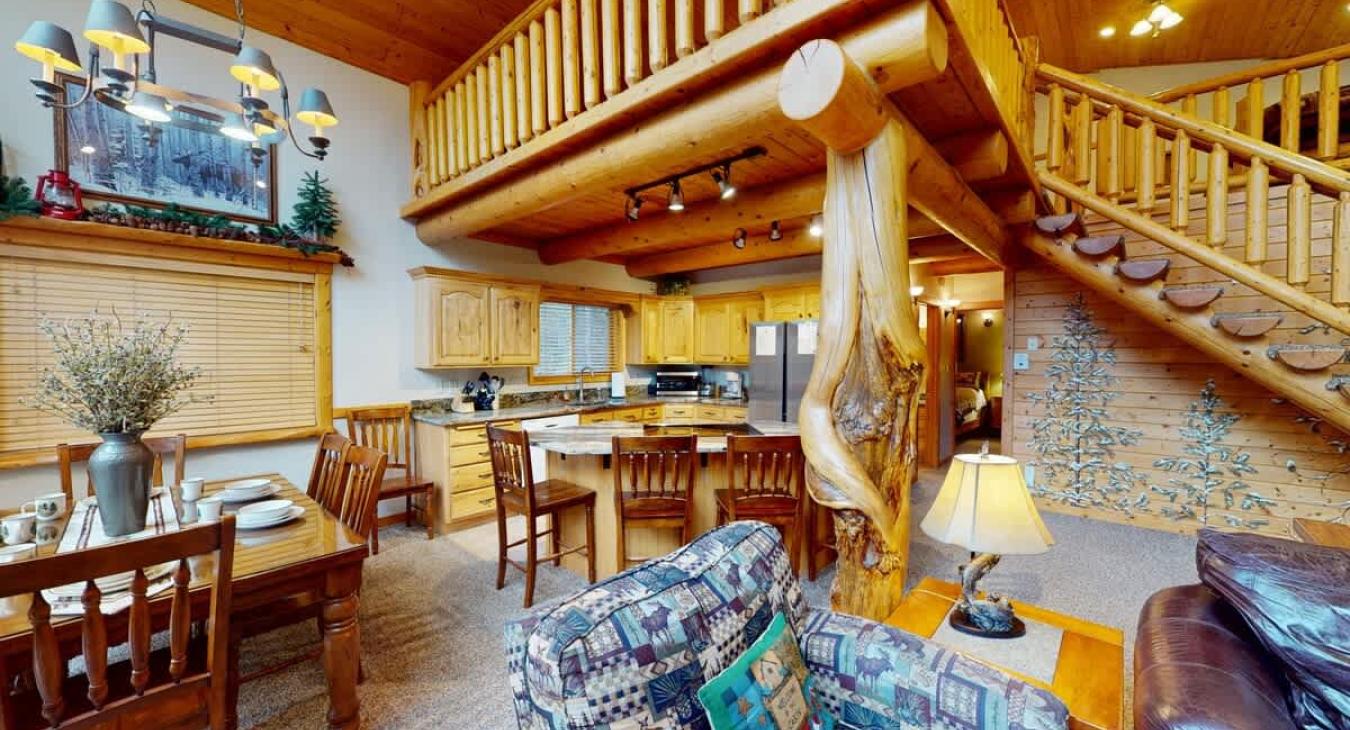 The interior is open-concept, blending the living area with a kitchen and dining space, giving it a warm, communal feel.