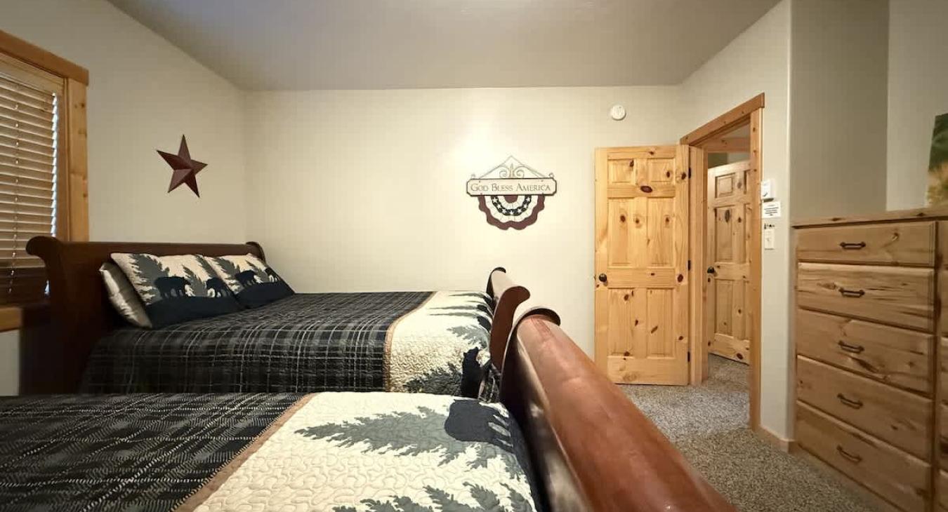 Bedroom #1 located in the basement, equipped with 2 Queen size beds.