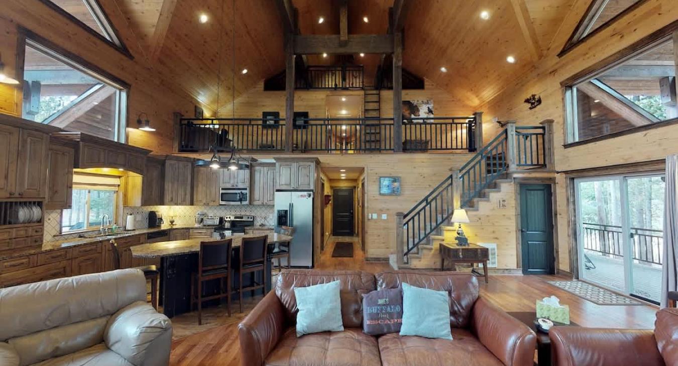 The open kitchen blends seamlessly into the cabin's cozy living area, creating a welcoming space perfect for gathering and unwinding.