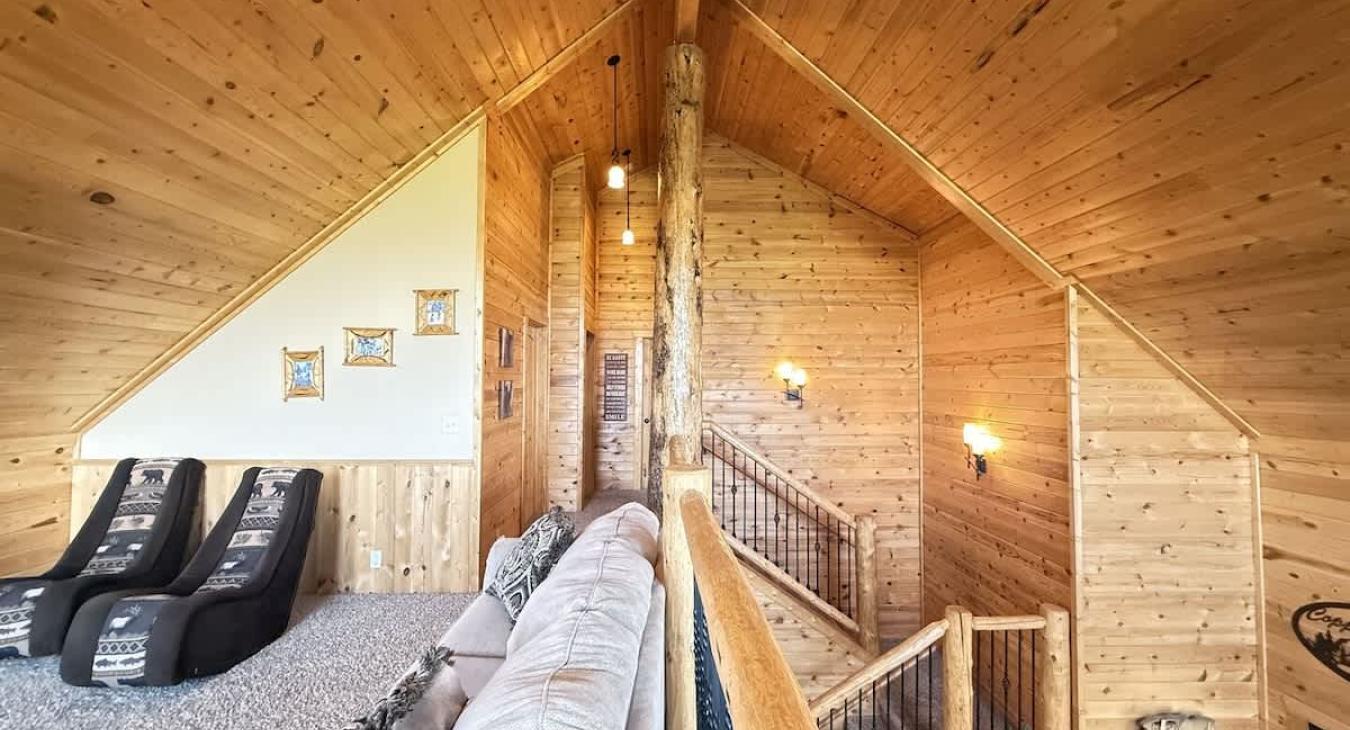 The loft has beautiful large windows to enjoy the view of the cabin.