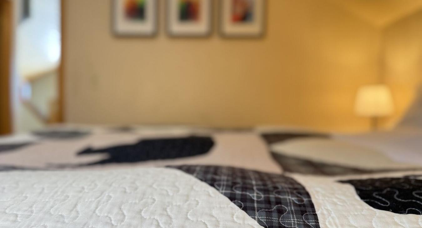 This bedroom feels like a serene sanctuary, offering a peaceful escape surrounded by nature.