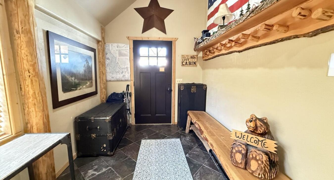 The entryway of the cabin has seating and storage during your stay.