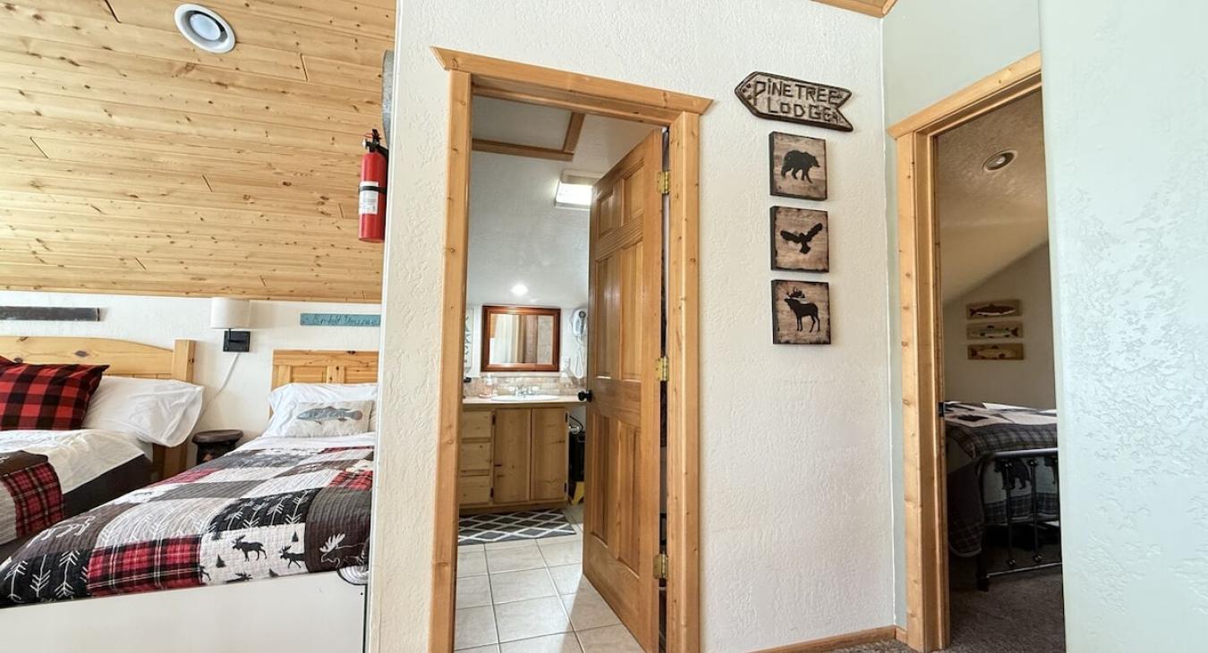 From the stairs you can view the loft beds, bathrooms, and entrance to the bedrooms.