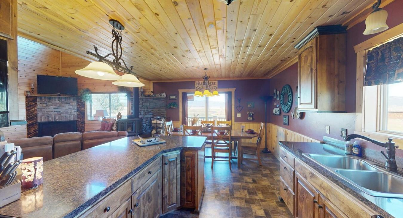 Full size kitchen with basic appliances, stove, fridge, microwave, and dishes.