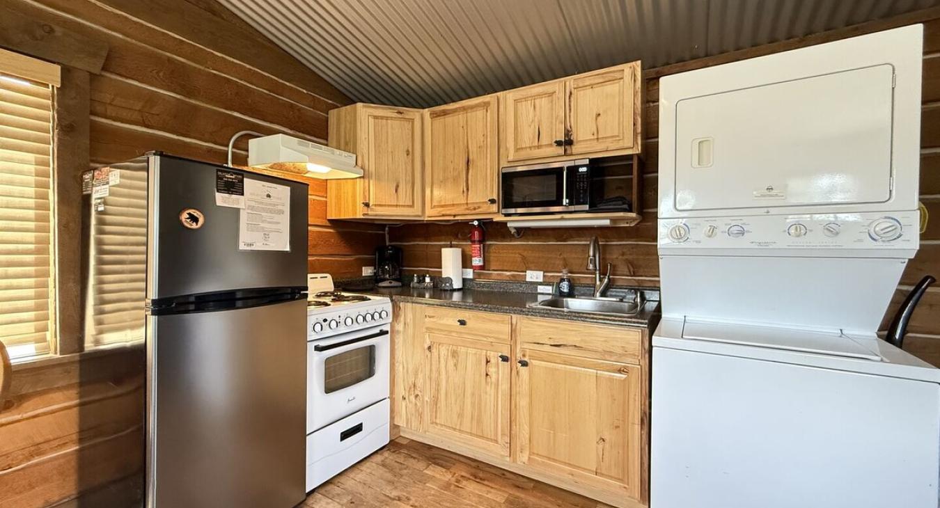 Kitchen area that is equipped with appliances, pots and pans, dishes, utensils, and basic cooking essentials.