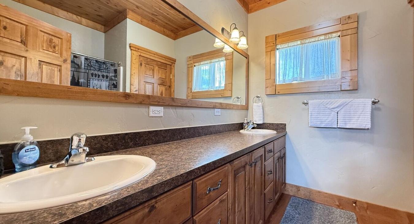 Shared bathroom on the main floor with shower tub combo, toilet, and sink vanity.