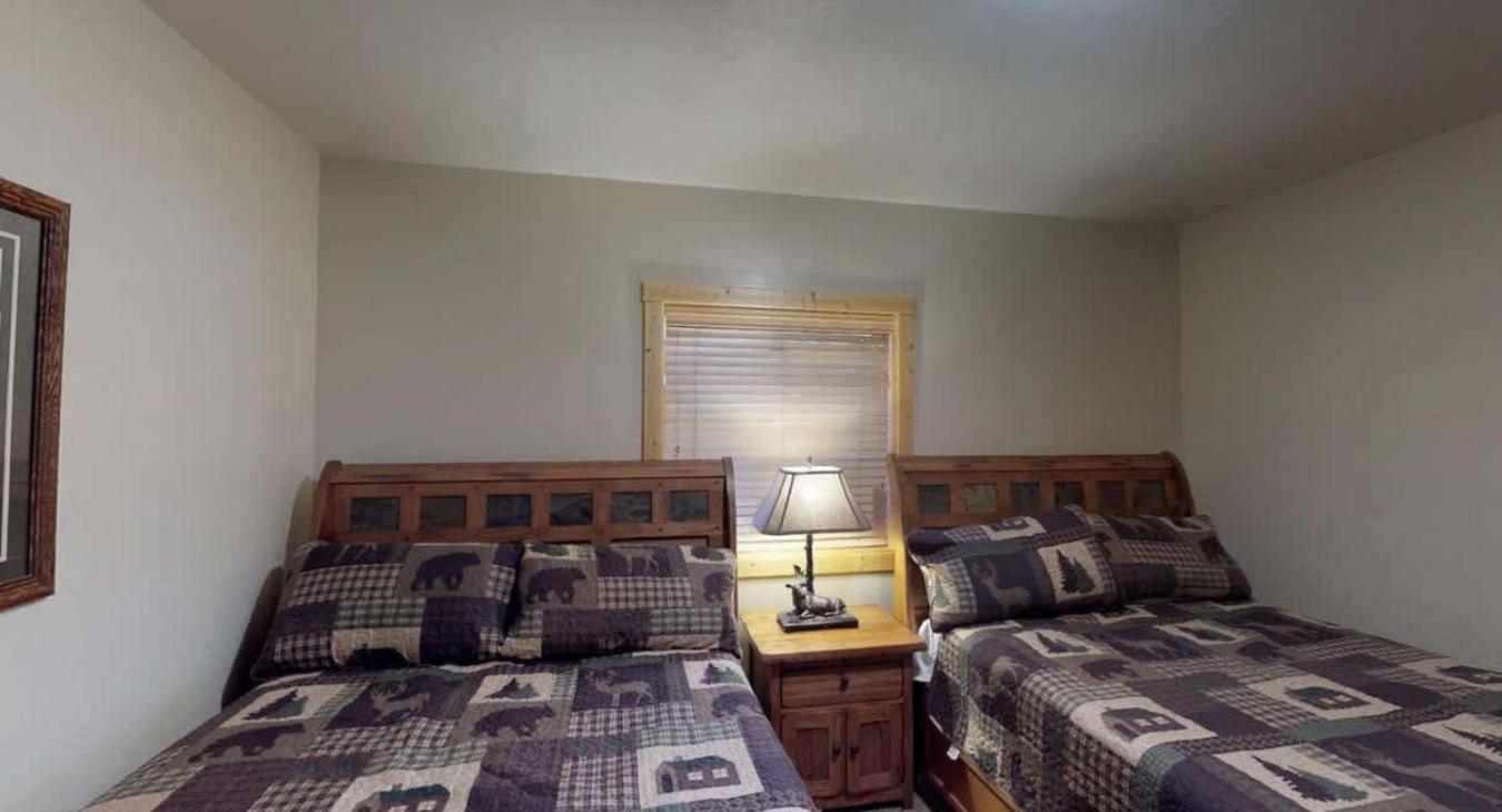 Bedroom #5 located in the basement with 2 Queen size beds.