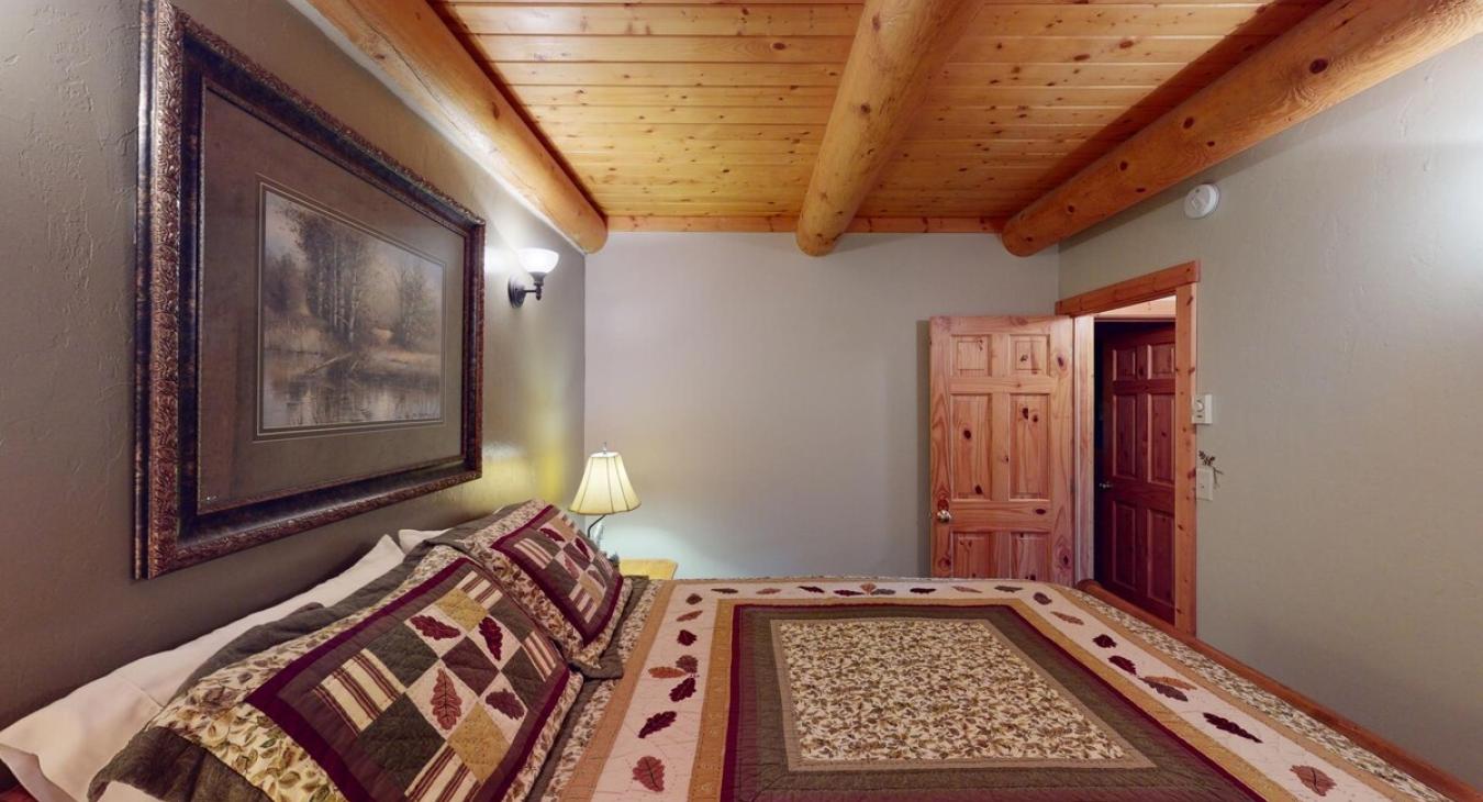Bedroom #1 located downstairs with a Queen size bed.
