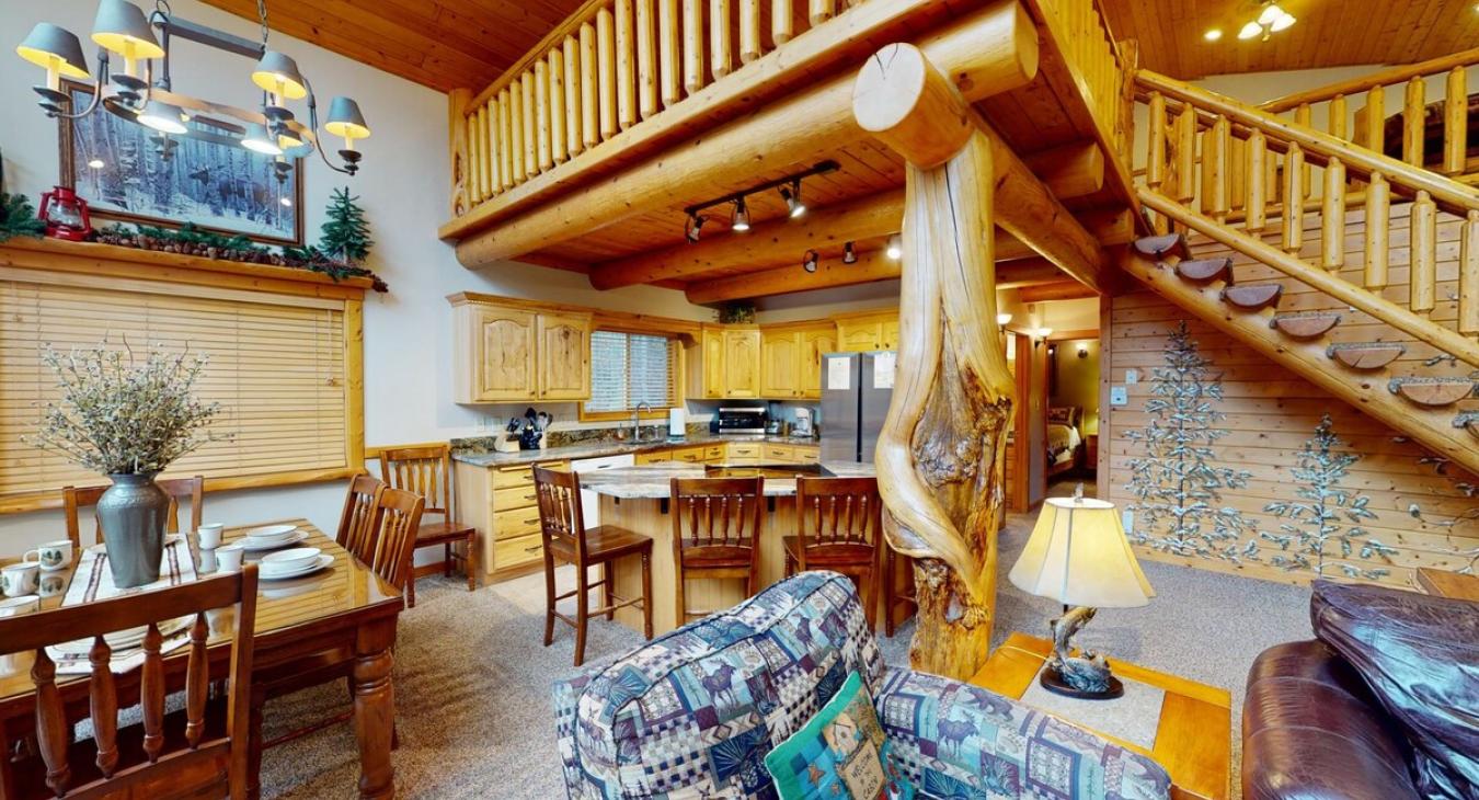 The interior is open-concept, blending the living area with a kitchen and dining space, giving it a warm, communal feel.