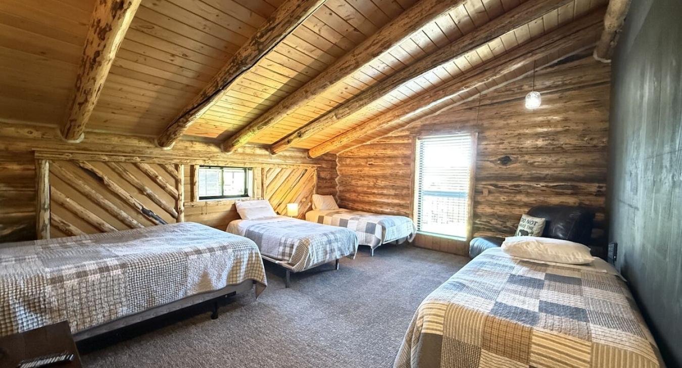 The first bedroom has 3 twins and 1 queen bed.