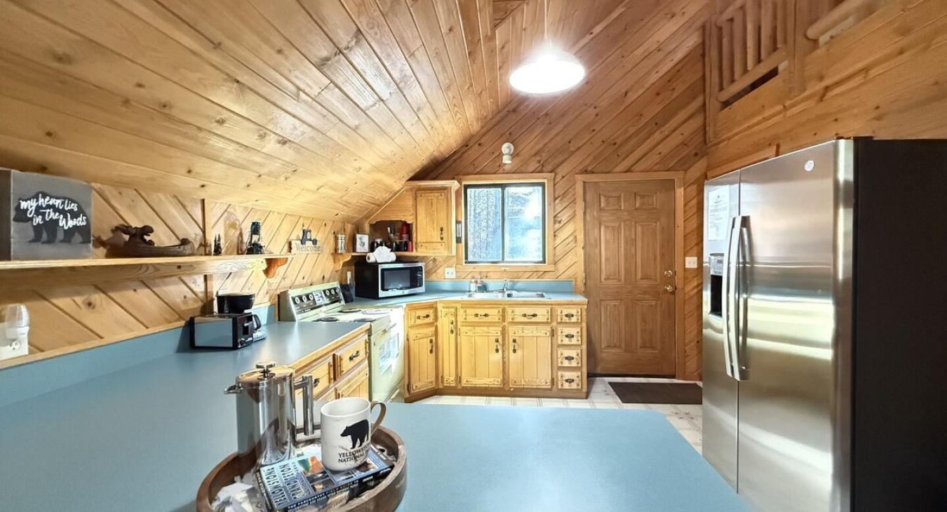 Kitchen with ladder to the loft area.