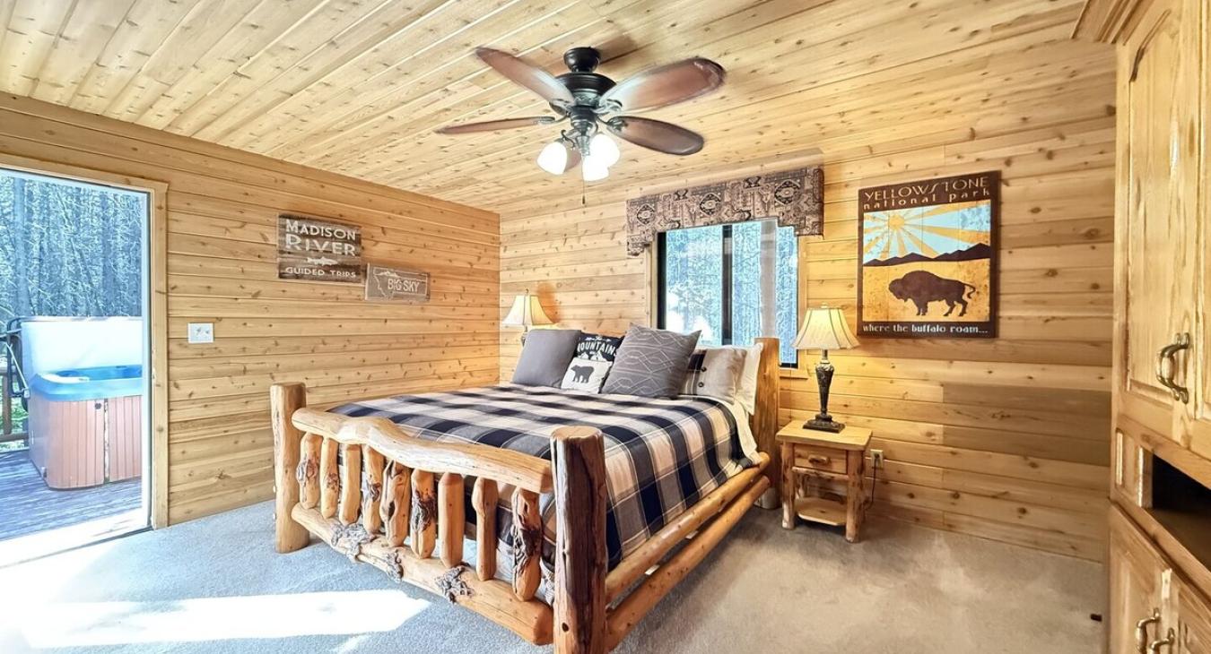 Master bedroom furnished with end stand tables, lamps, and a luggage rack.