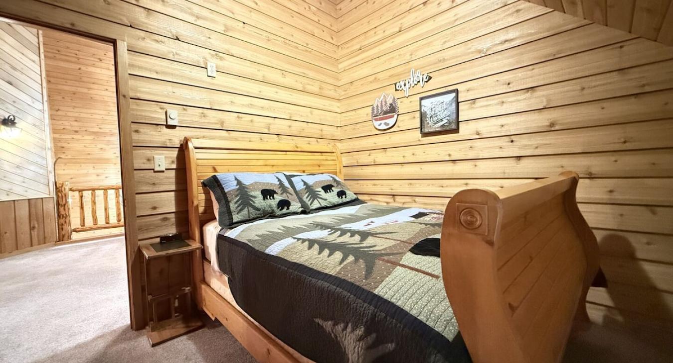 Queen size bed located upstairs.