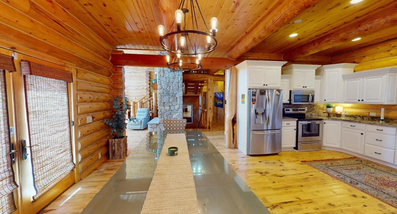 Overall, this dining room is a place where friends and family can gather, share meals, and enjoy the connection between nature and the comfort of a well-loved cabin home.