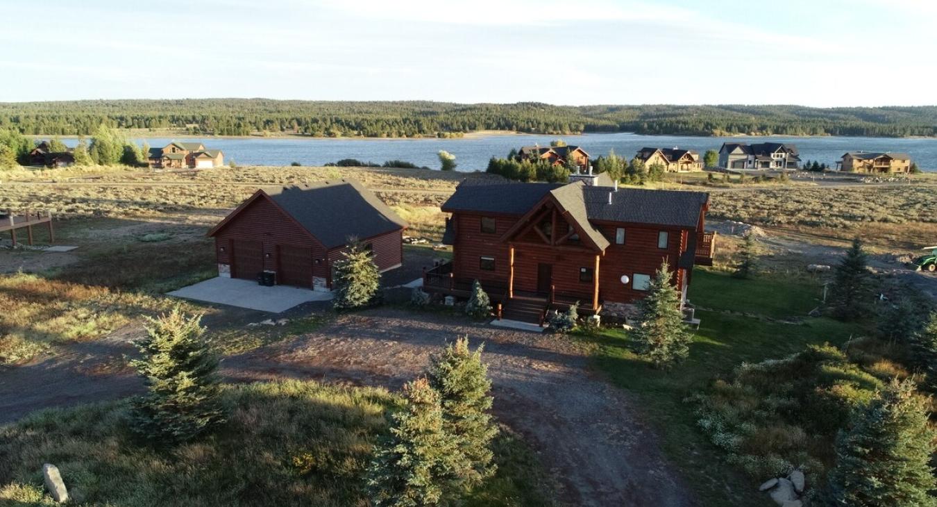 Whether it's the log walls, the expansive windows, or the inviting porch, everything about the exterior invites you to relax and immerse yourself in the beauty of nature.
