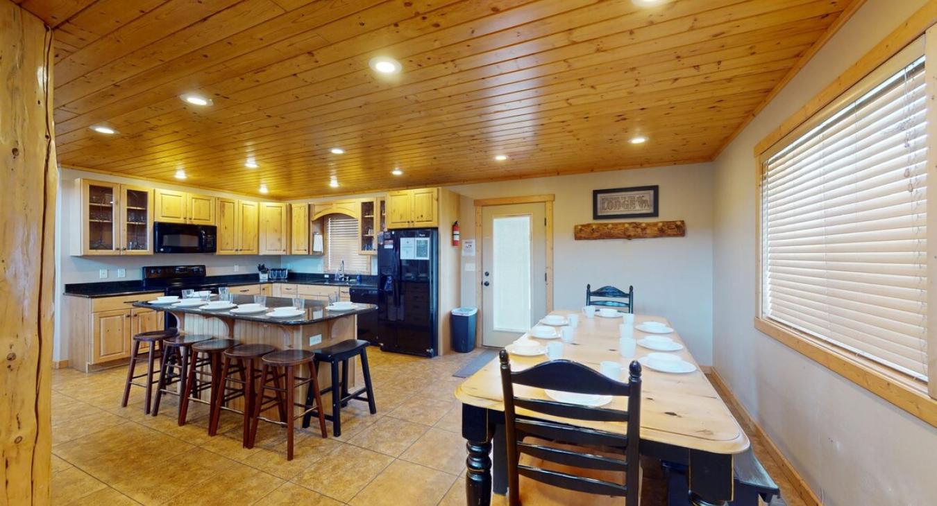 Large dining table and island chairs to seat everyone.