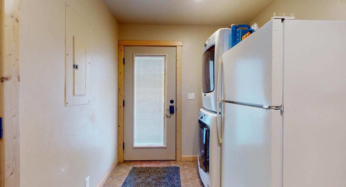 Stacked washer and dryer for your use. Laundry soap is provided.