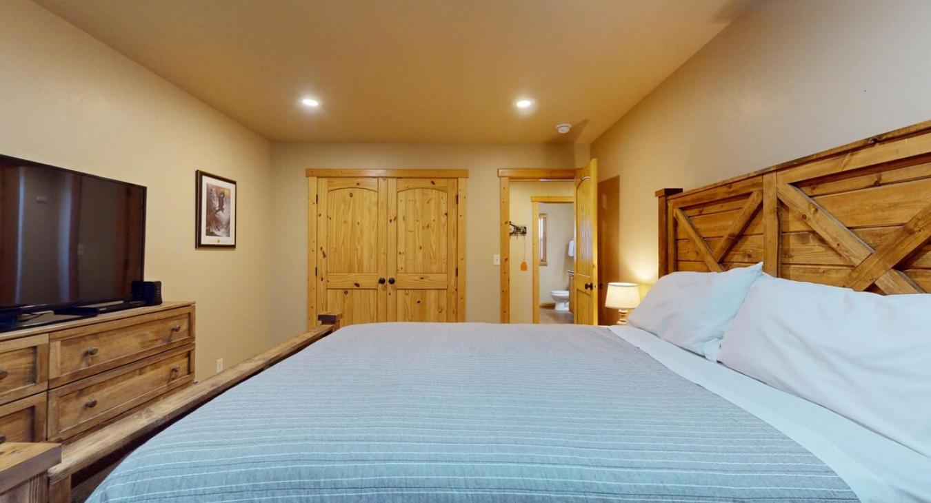 Queen bed and closet located in this room.