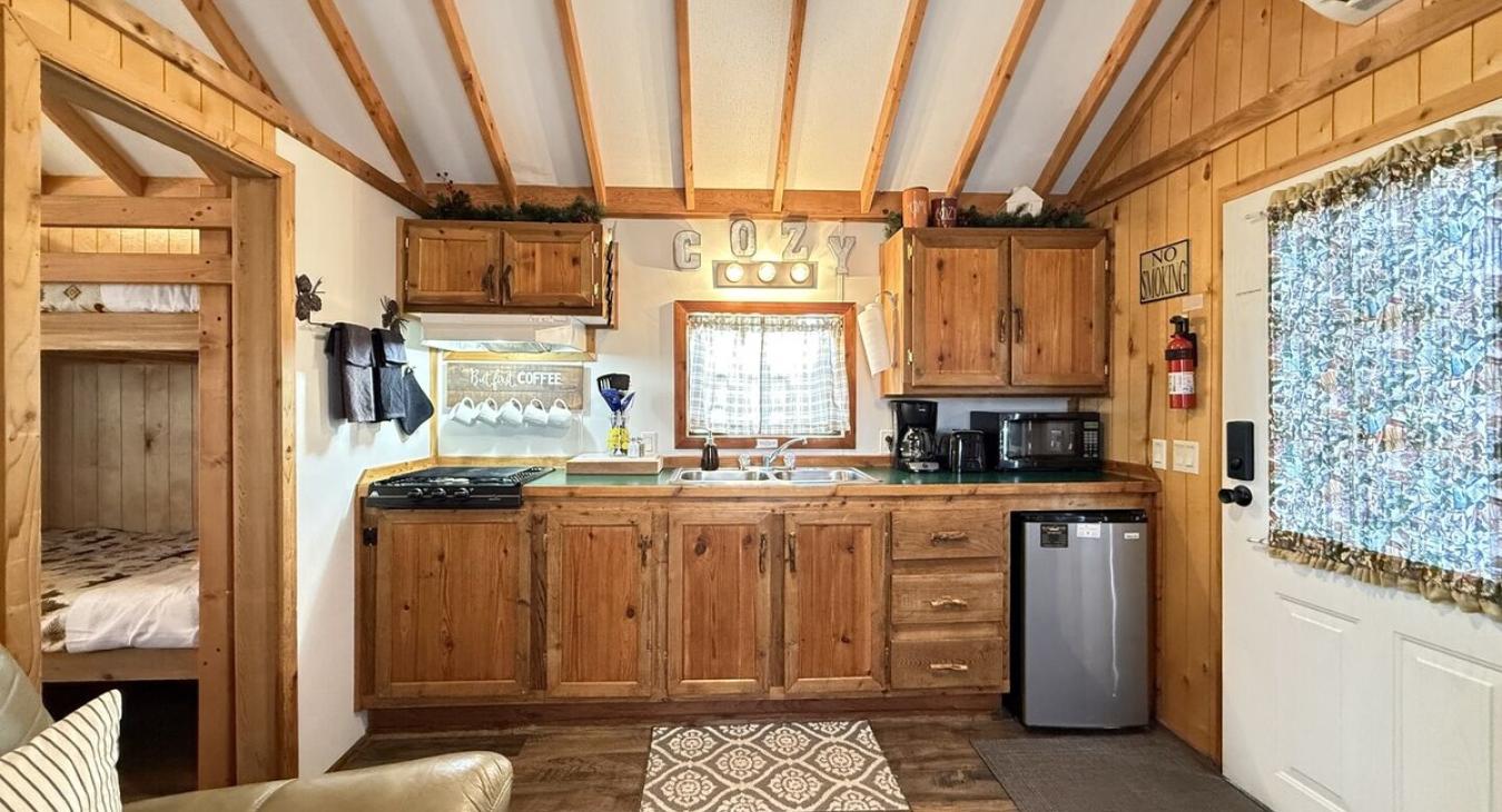 This cozy kitchen has the necessities needed for making a small meal or brewing up a cup of coffee.