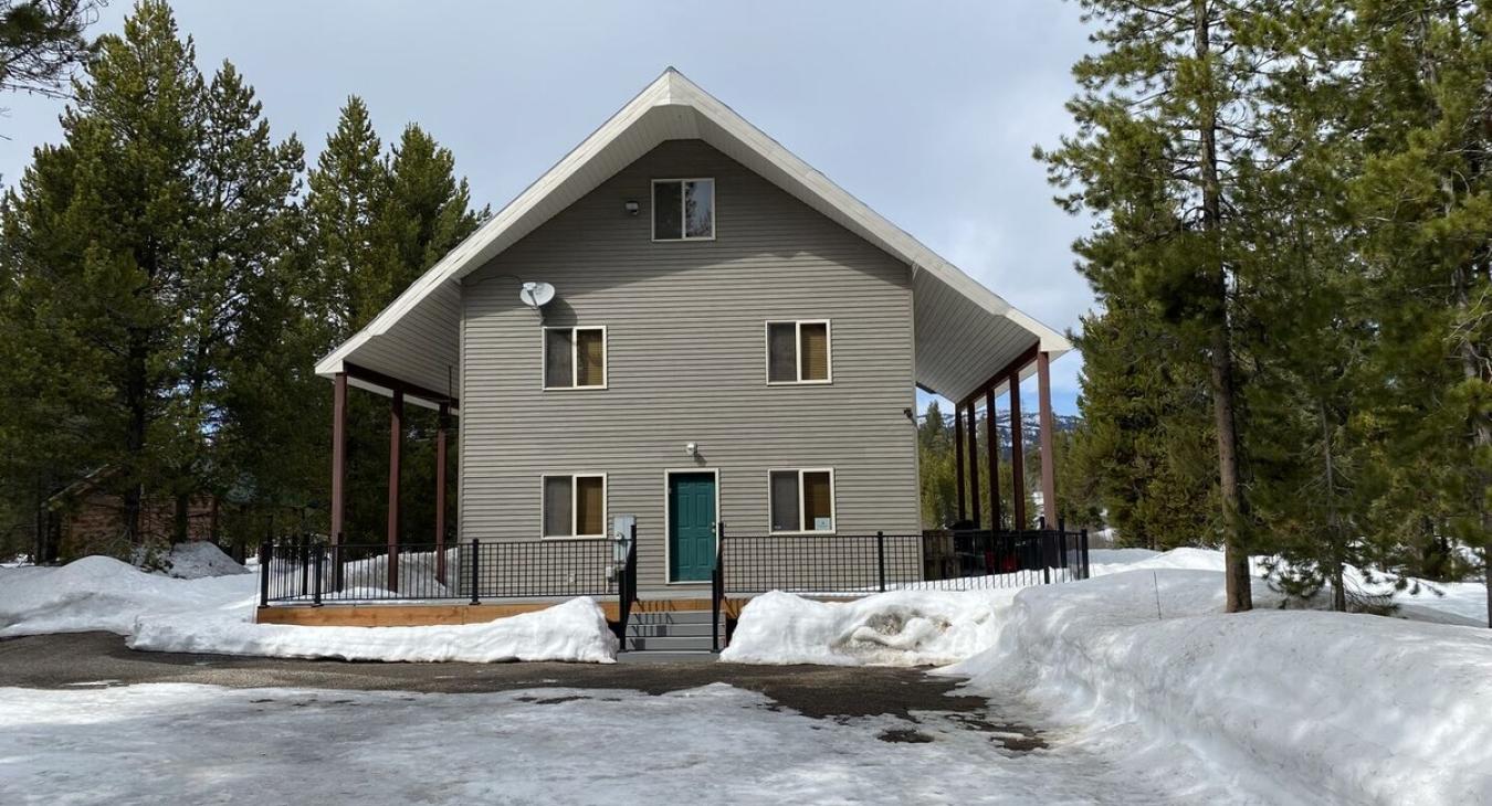 Beautiful cabin that is nestled in the towering pine trees.