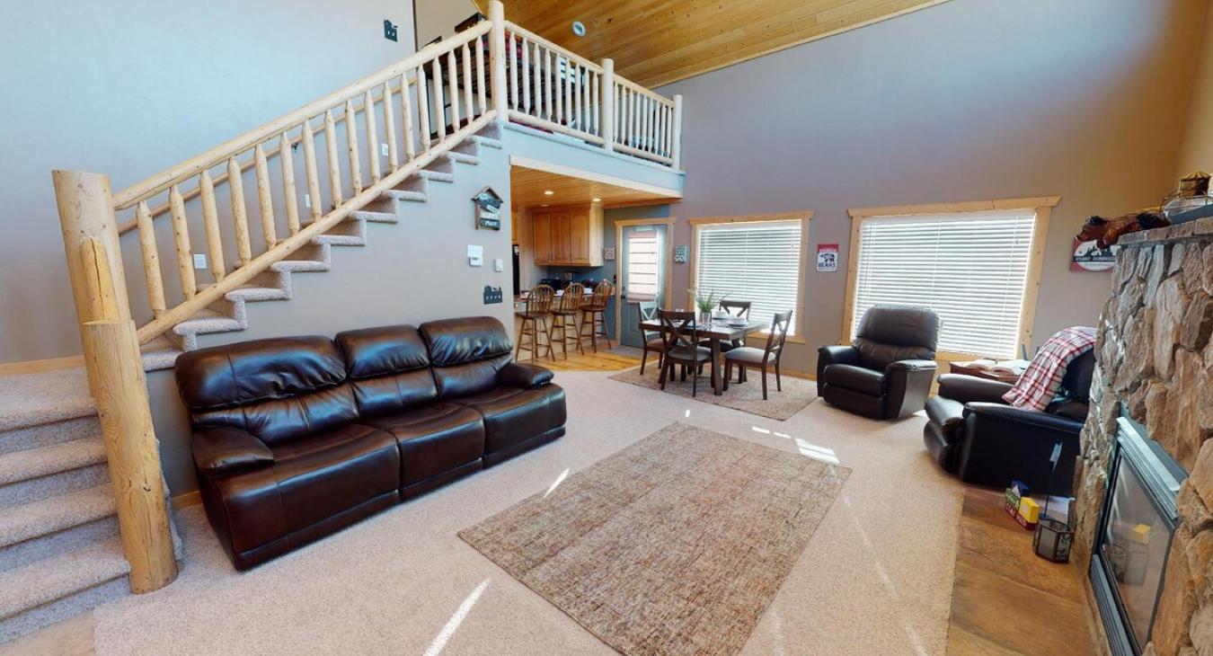 Open living room that can lead you upstairs or to the kitchen.