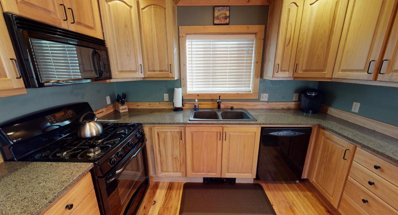 This kitchen is equipped with everything you might need to cook a home cooked meal.