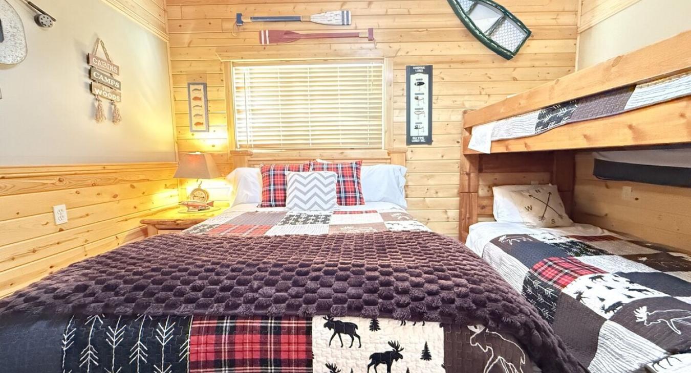 Welcome to the third bedroom with a queen bed and 2 twin beds on a bunk bed.