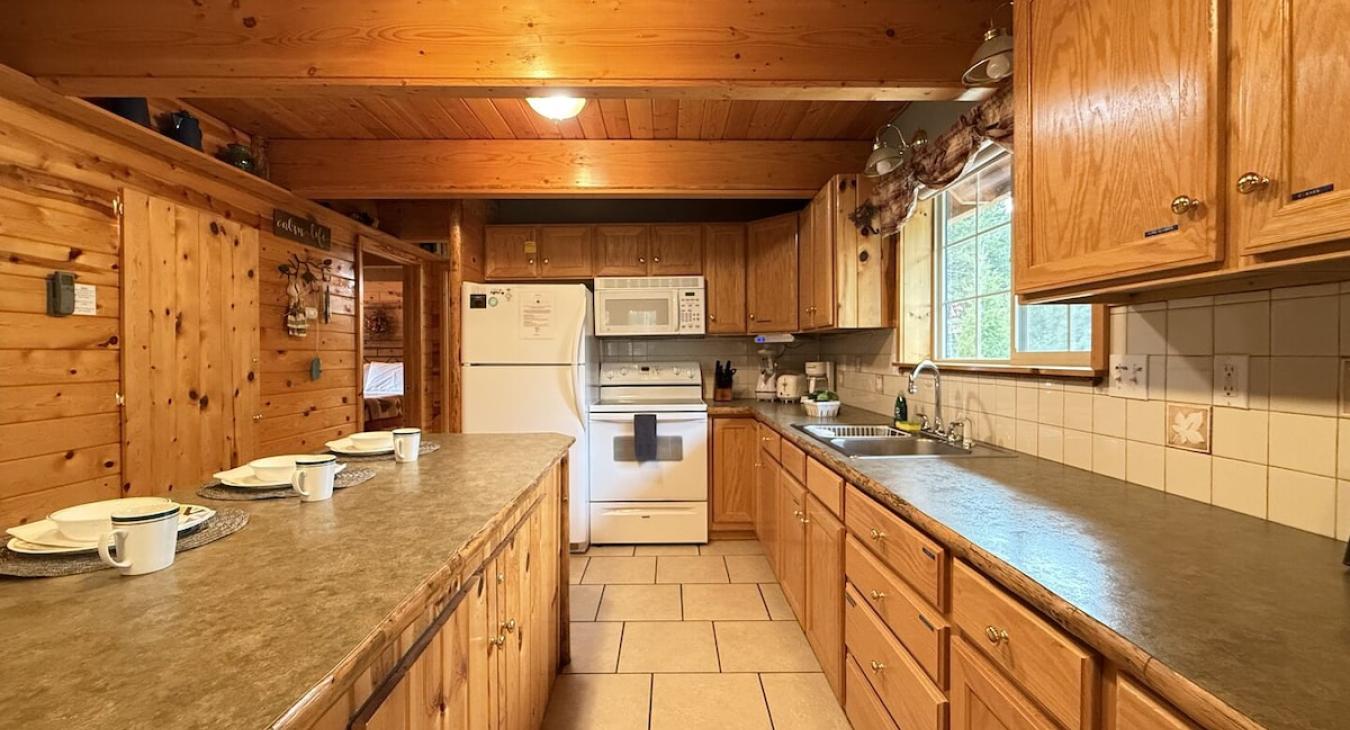 Full size kitchen with appliances, cookware, pots and pans, utensils, dishes, and basic cooking essentials.