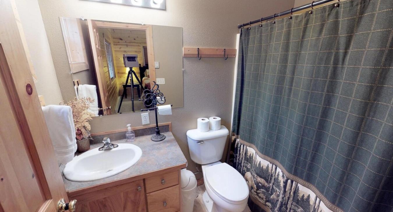 The master bathroom with plenty of storage as well as a vanity sink, toilet, and shower tub combo. Relax in this bathroom after a long day.