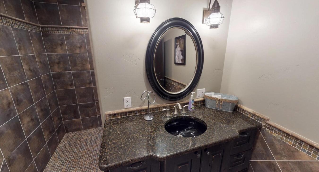 A toilet and sink vanity is also included in the bathroom.
