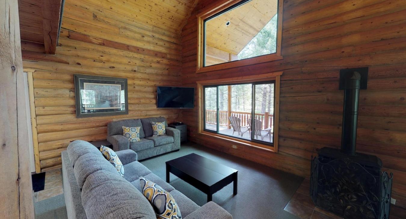 Main level living area with seating, TV, and fireplace.