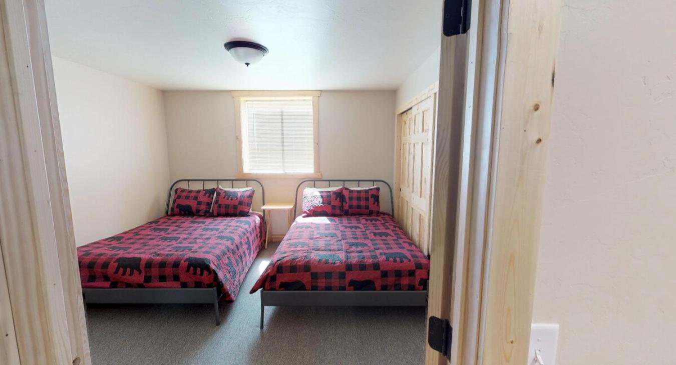 Bedroom #5 located in the basement with 2 Double beds.