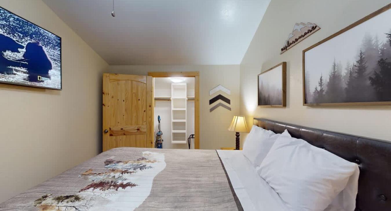 The queen bed and closet offer a cozy environment.