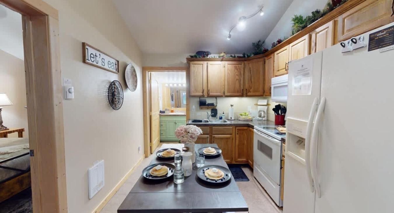 The dining room table is conveniently located within the kitchen for easy access during meals.