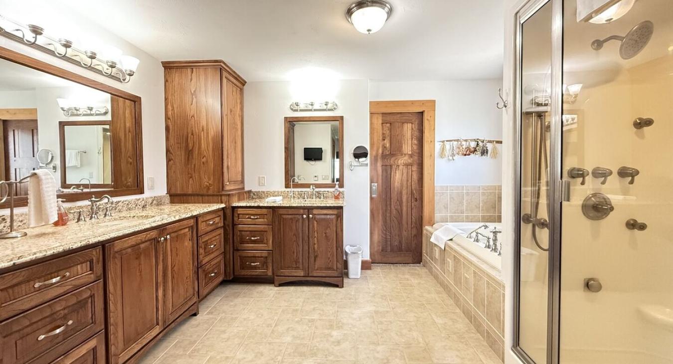 Ensuite Master Bathroom with tub, standing shower, toilet, bidet, and double sinks.
