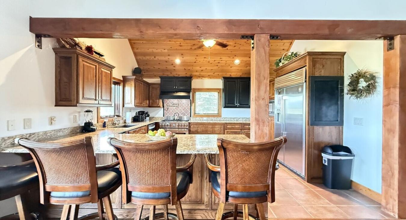 The open kitchen blends seamlessly into the cabin's cozy living area, creating a welcoming space perfect for gathering and unwinding.