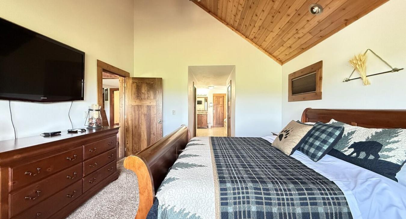 Master bedroom located on the main floor with a King size bed.