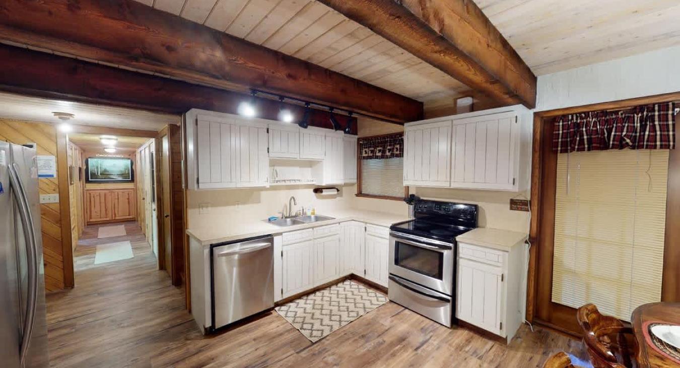 Full size open kitchen with appliances, pots and pans, cookware, dishes, and basic cooking essentials.