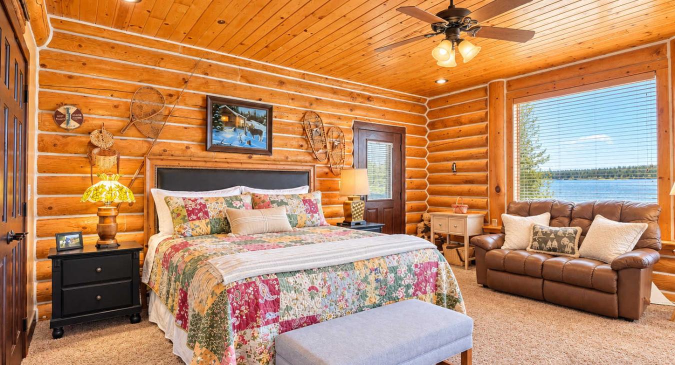 Master bedroom with a king size bed and sitting area overlooking the lake.