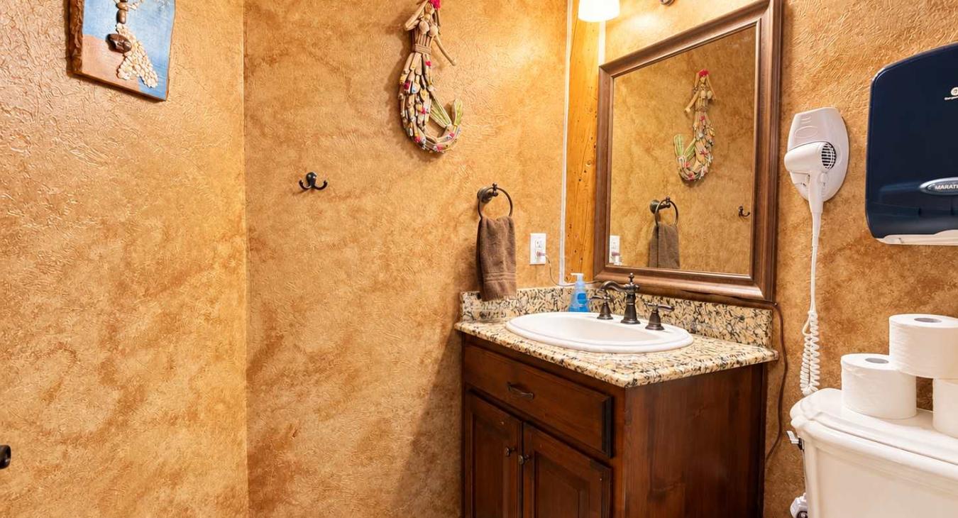 Half bathroom located on the main level across from the laundry room.