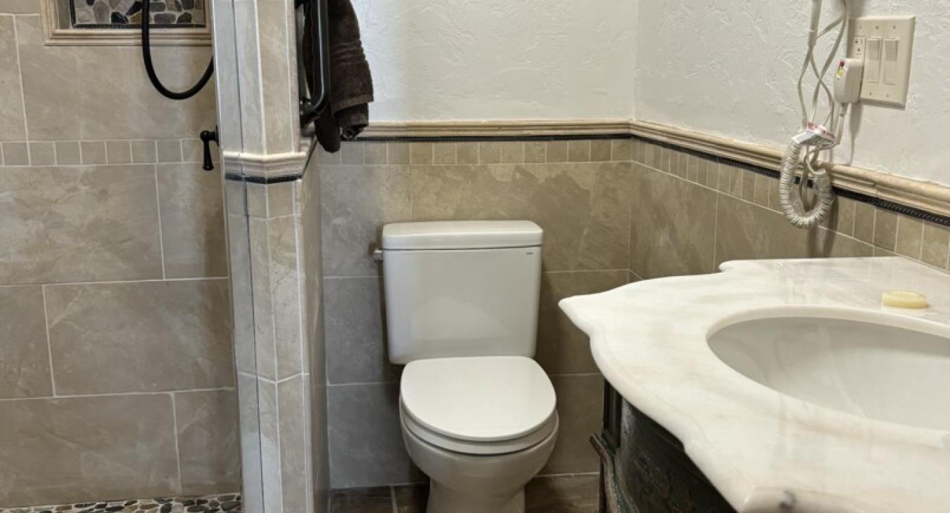 1st bathroom downstairs with walk-in shower, toilet, and sink.