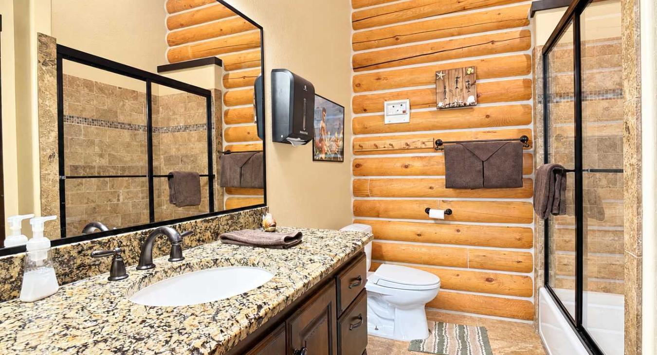 2nd bathroom upstairs located in the hallway with a shower/tub combo, toilet, and sink vanity.