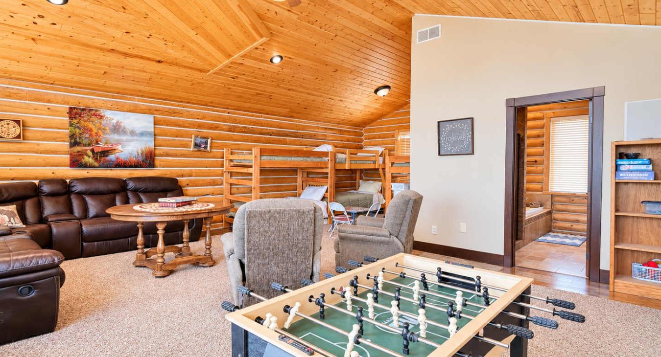 Upstairs loft is equipped with sectional couch, satellite tv, and foosball table.