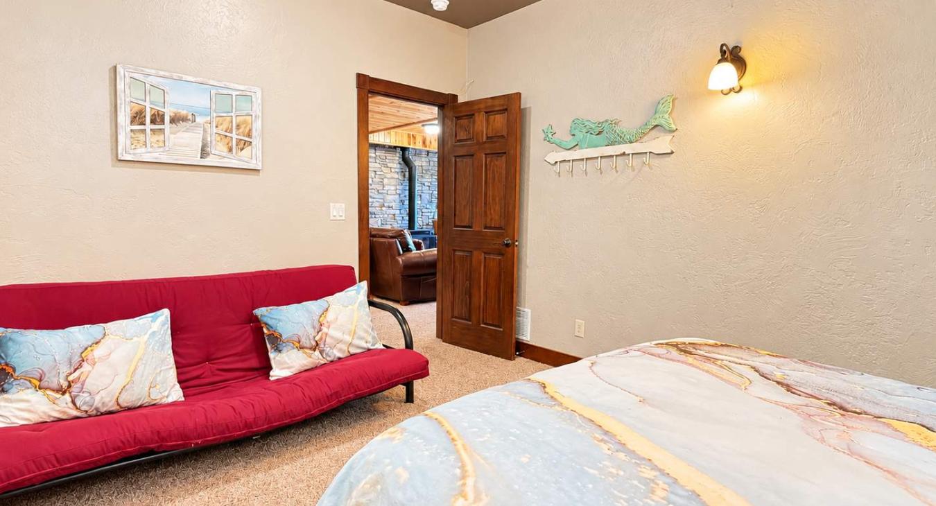 Basement Bedroom #2 has a mermaid theme and a futon couch.