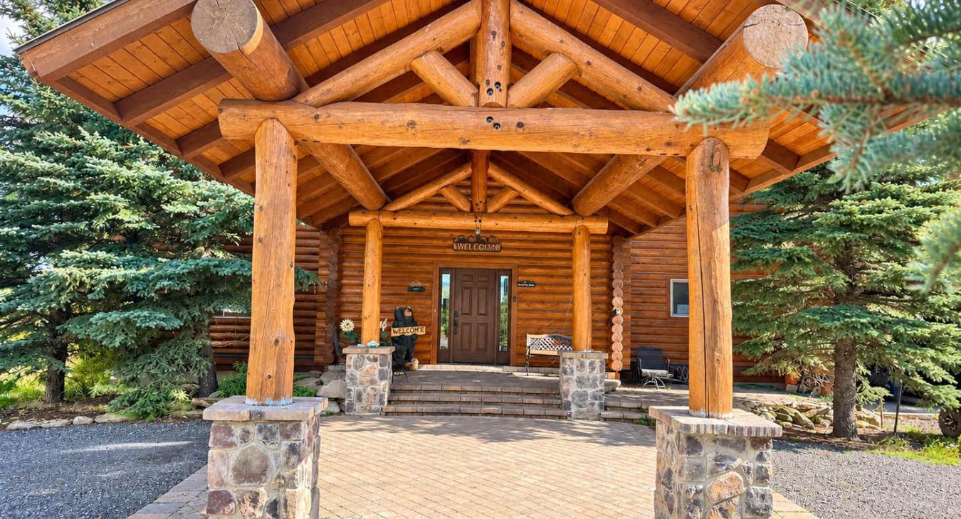 Beautiful front entrance of the cabin. Covered pull through drive.