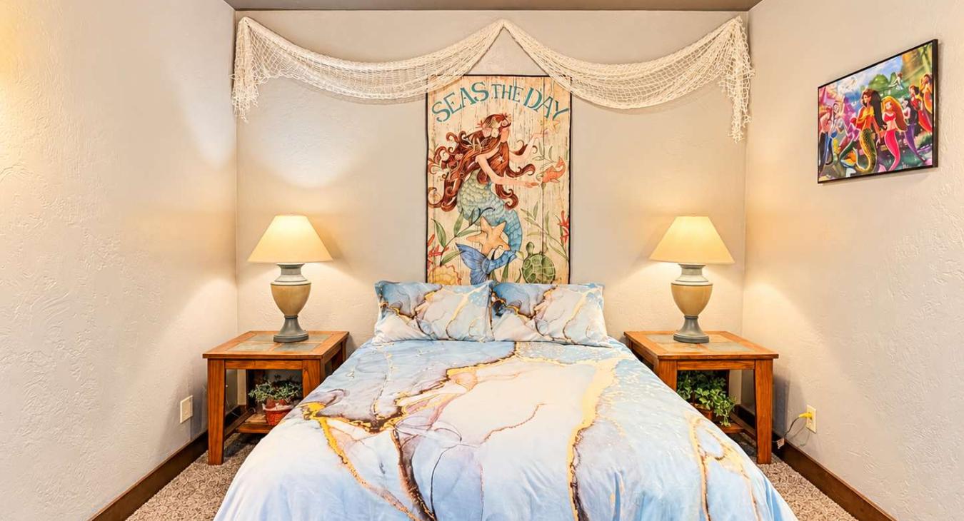 Basement Bedroom #2 is located downstairs with a Queen size bed and a mermaid theme.