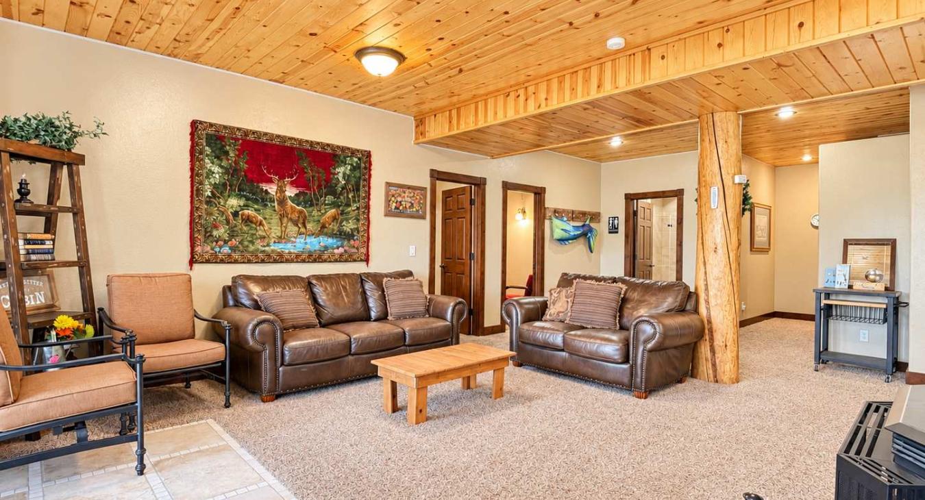 Downstairs living area with fireplace and seating.