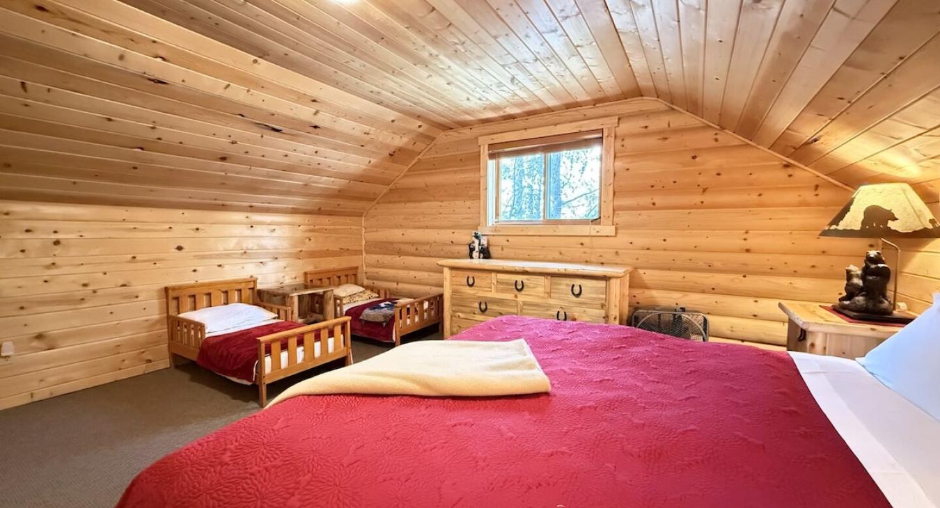 King upstairs bedroom with dresser and small closet. Also 2 kids beds. (Bring your own bedding)